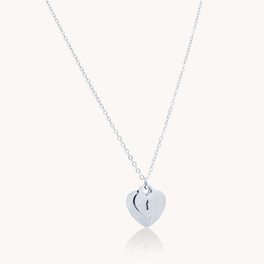 Silver double heart necklace with keyhole detail in stainless steel – waterproof & tarnish-free.