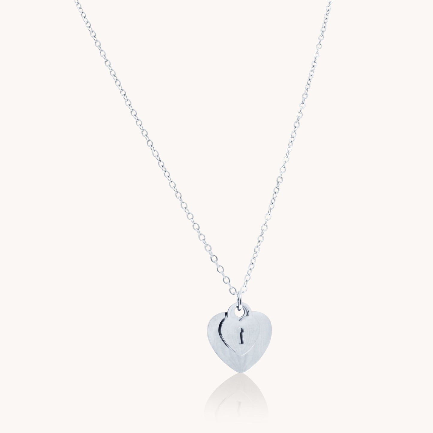 Silver double heart necklace with keyhole detail in stainless steel – waterproof & tarnish-free.